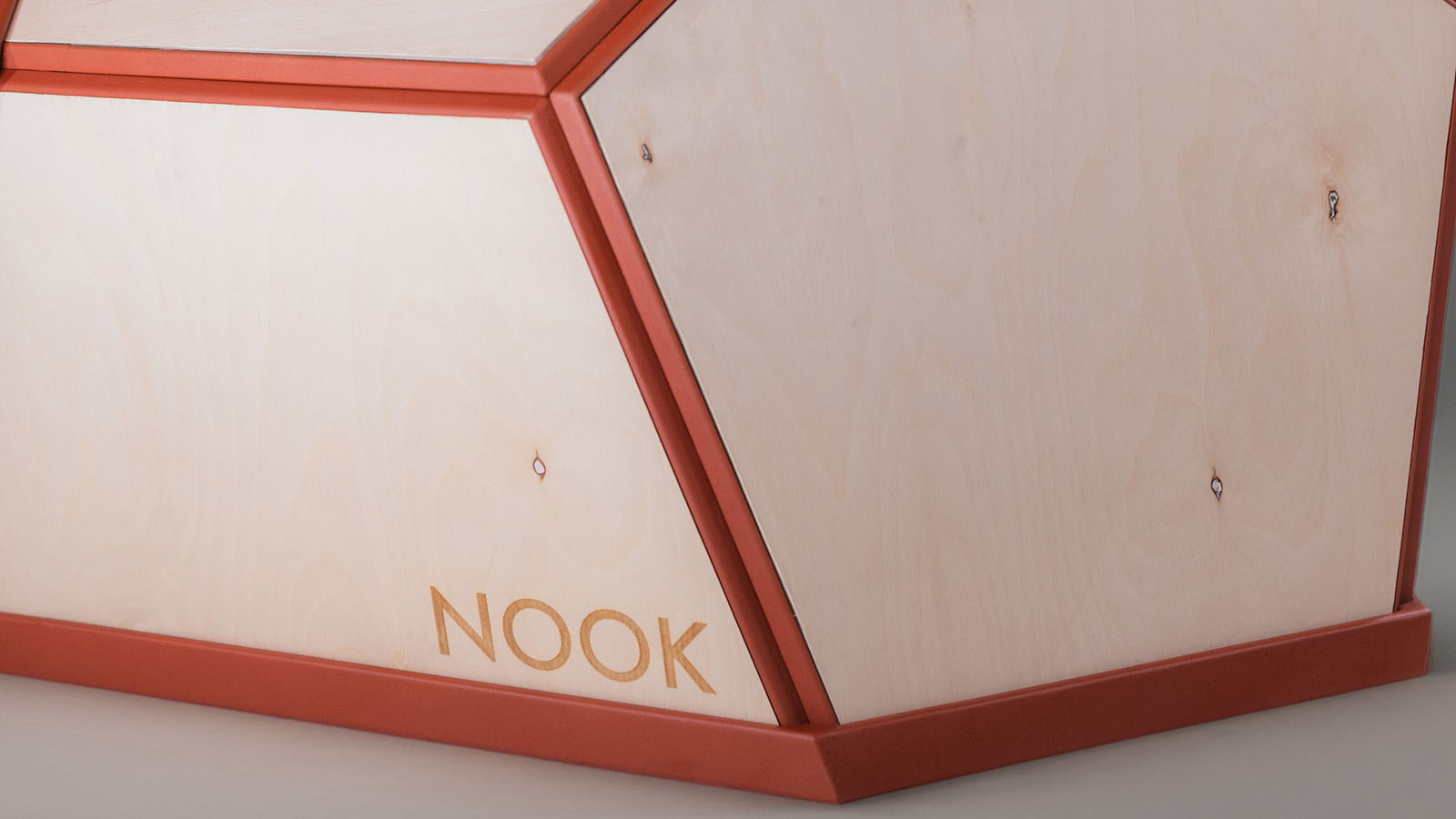 Close-up of NOOK showing the decorative veneer layer, red plastic frame, panel connections, and product logo