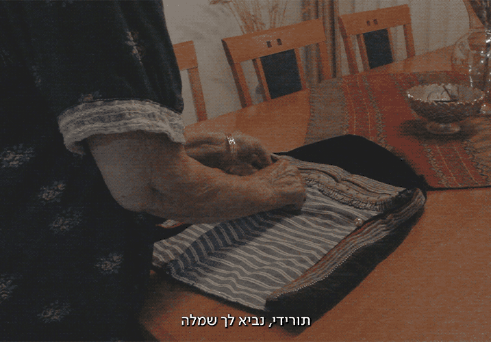A woman folds a Yemenite hat