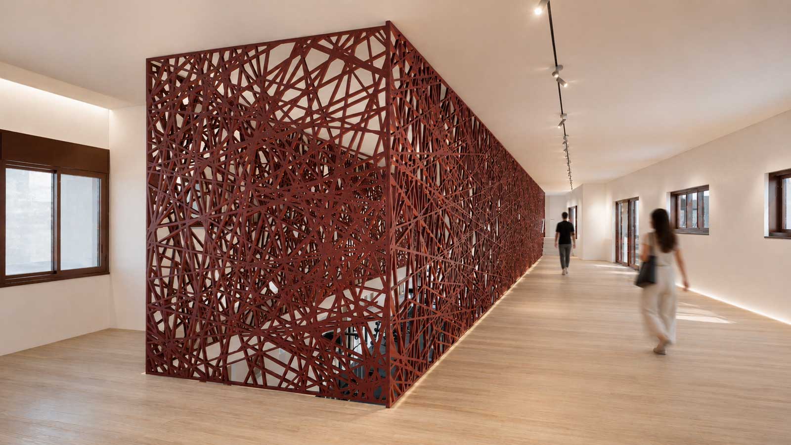 Residential Floor Corridor – A view into the gym, creating a visual connection between levels.